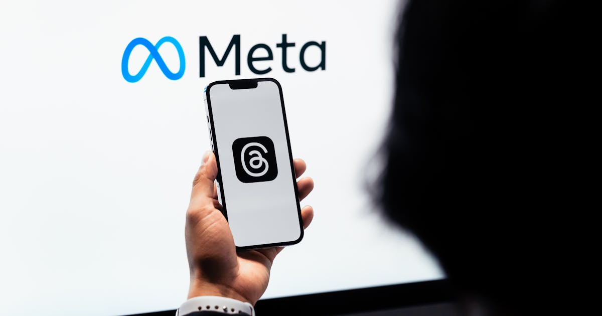 Hands holding smartphone with Meta app on screen — Meta retargeting ads guide for Chennai businesses