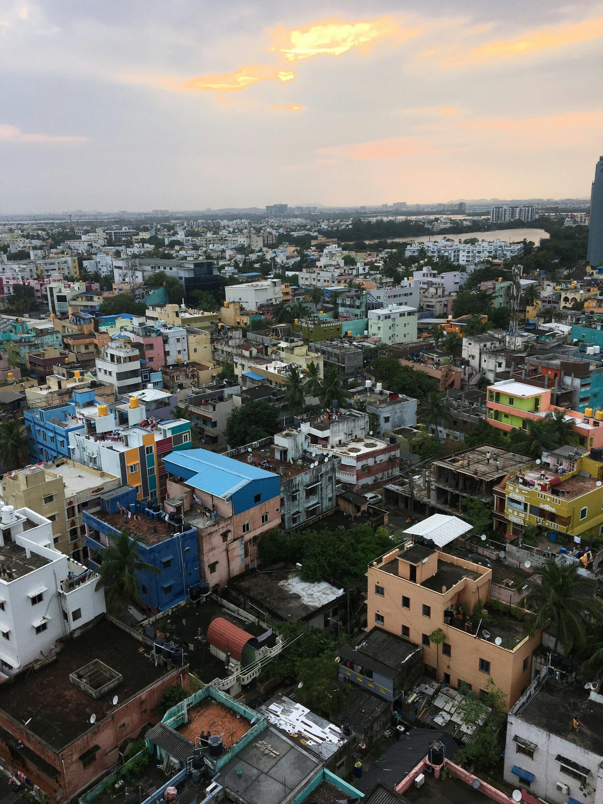 Vibrant cityscape showcasing diverse architecture under a sunset sky, offering a unique blend of urban life.