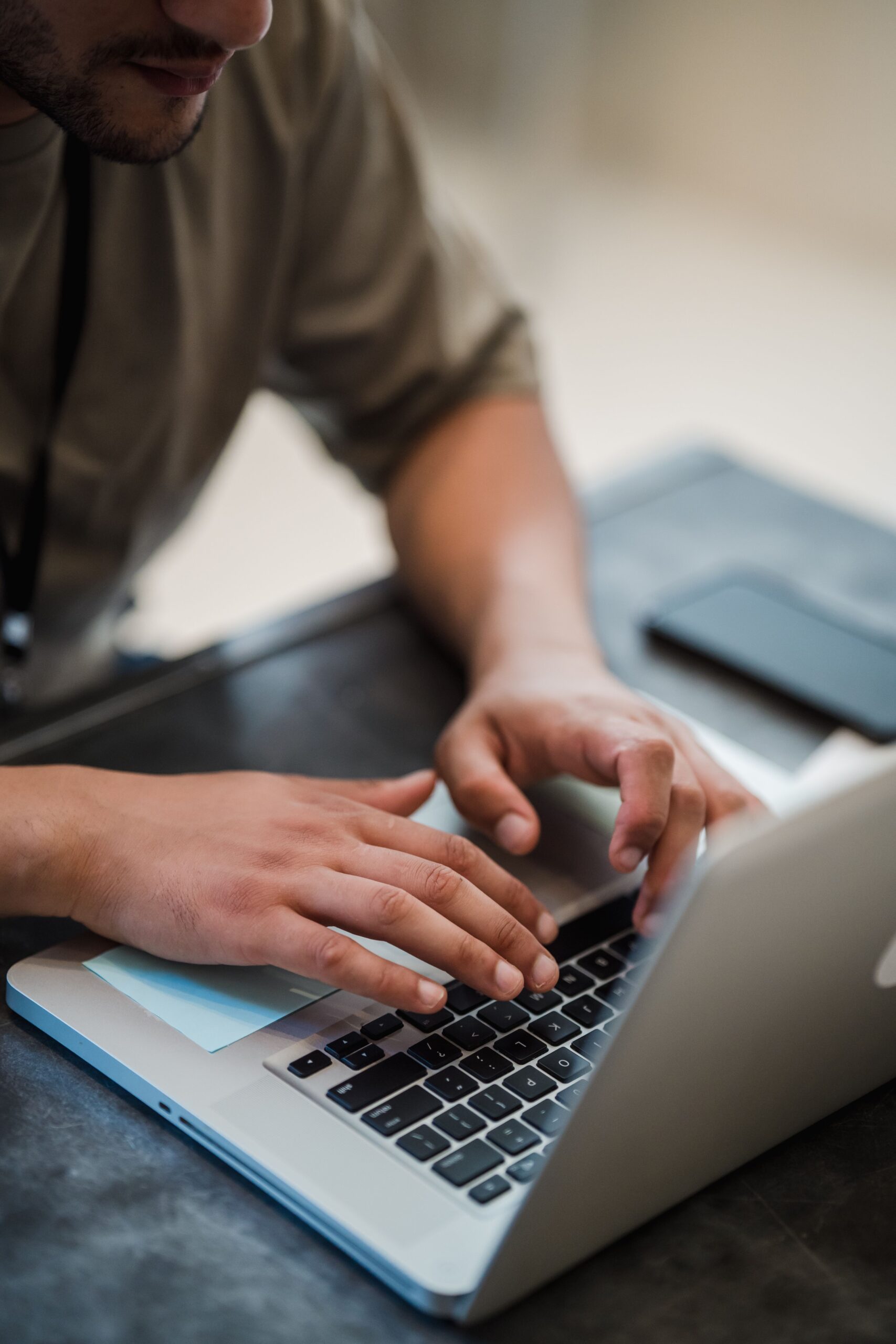 Hands typing on a laptop keyboard