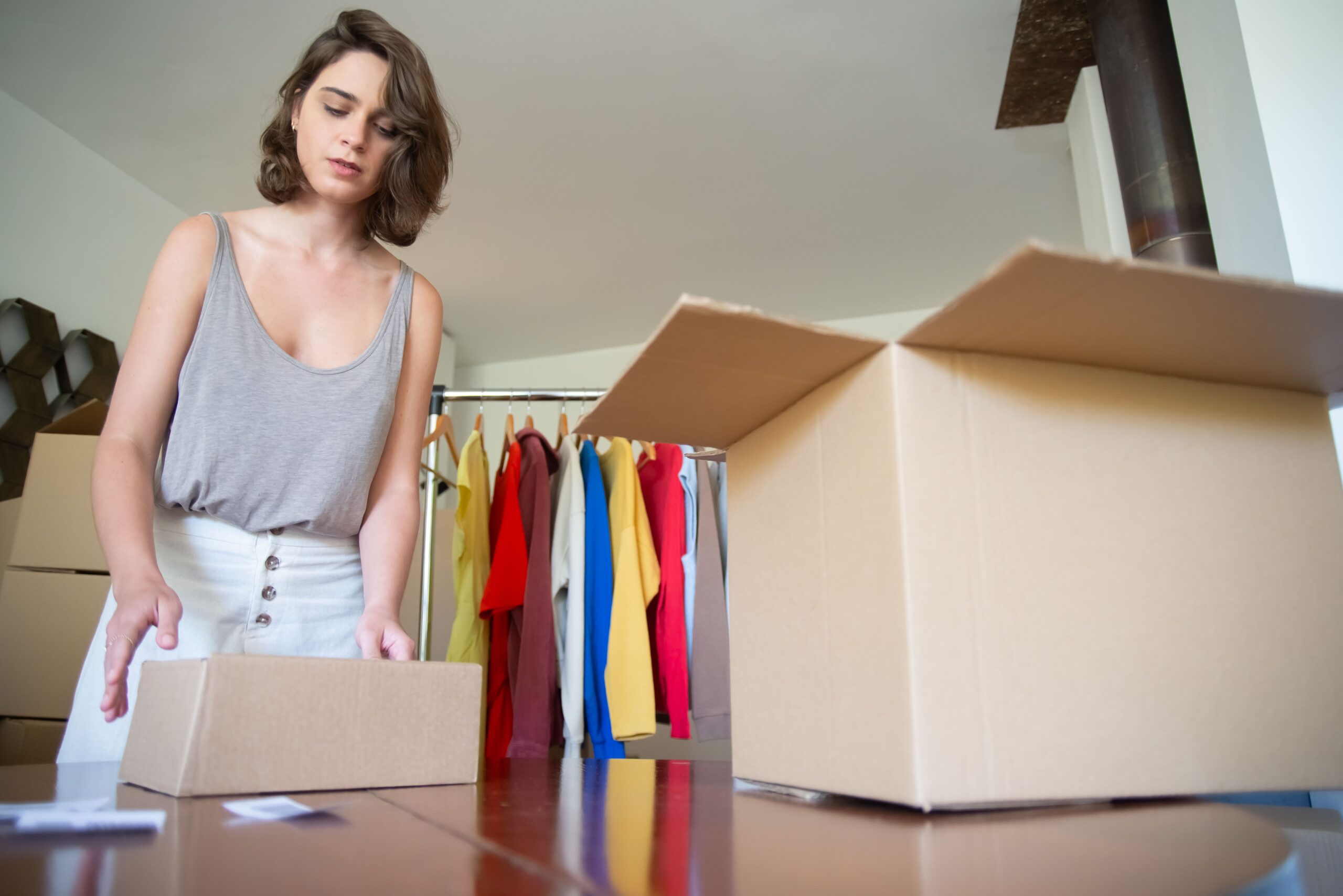 Small business owner packing a customer order after a WhatsApp sale